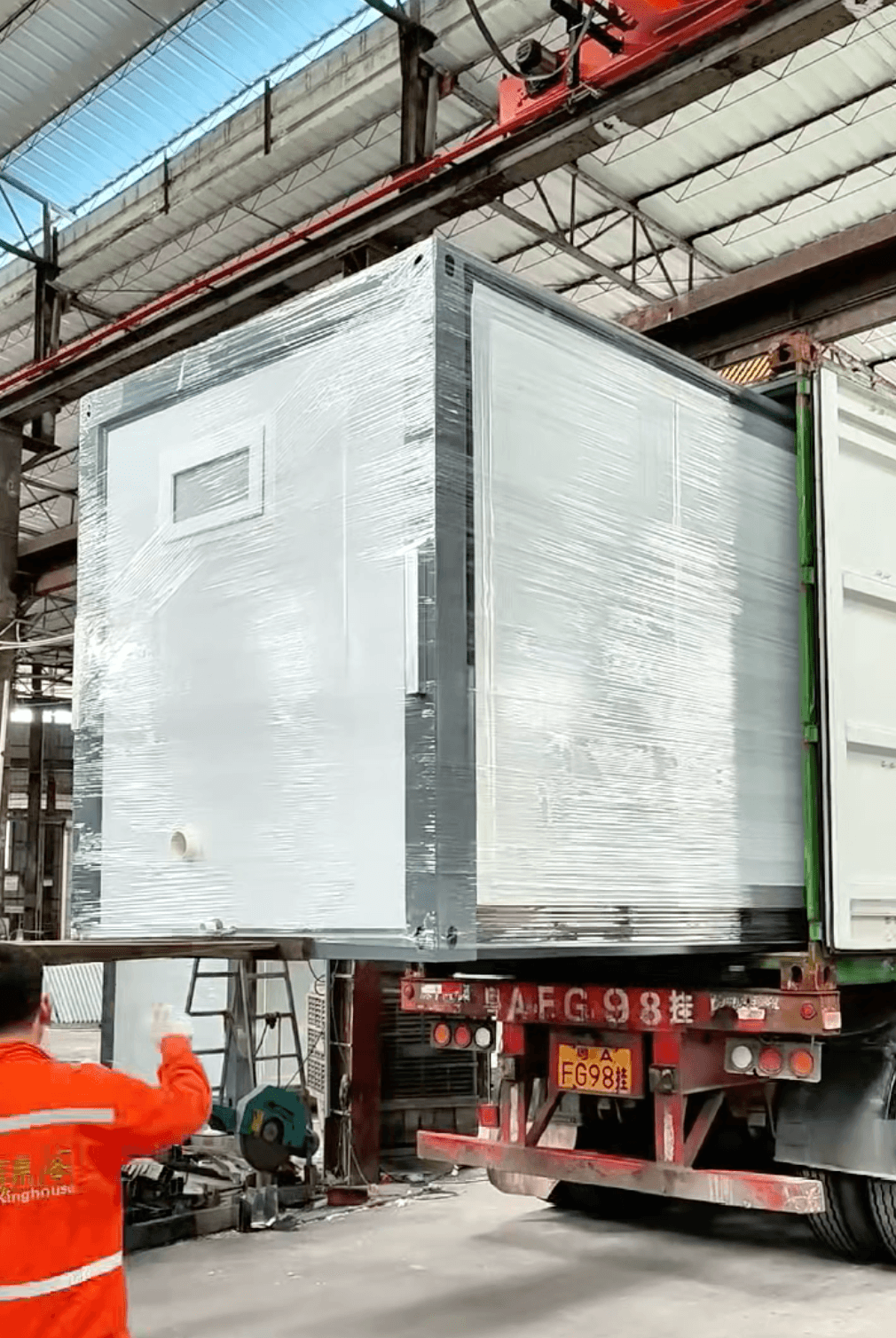 Factory dispatch — wrapped unit being loaded onto transport