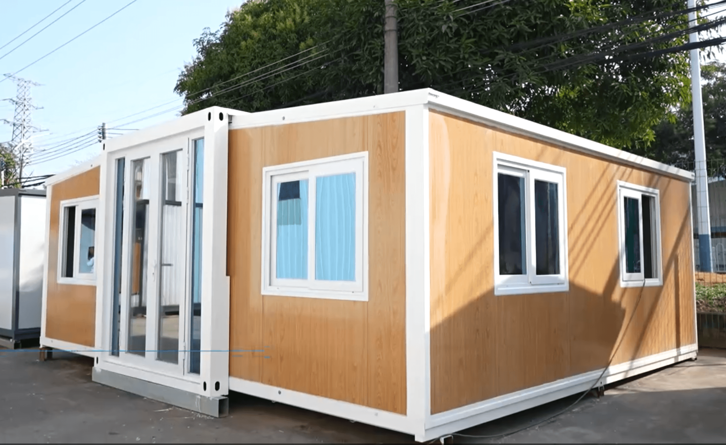 Expandable granny flat kit in Australian backyard — signature two-tone wood and white finish