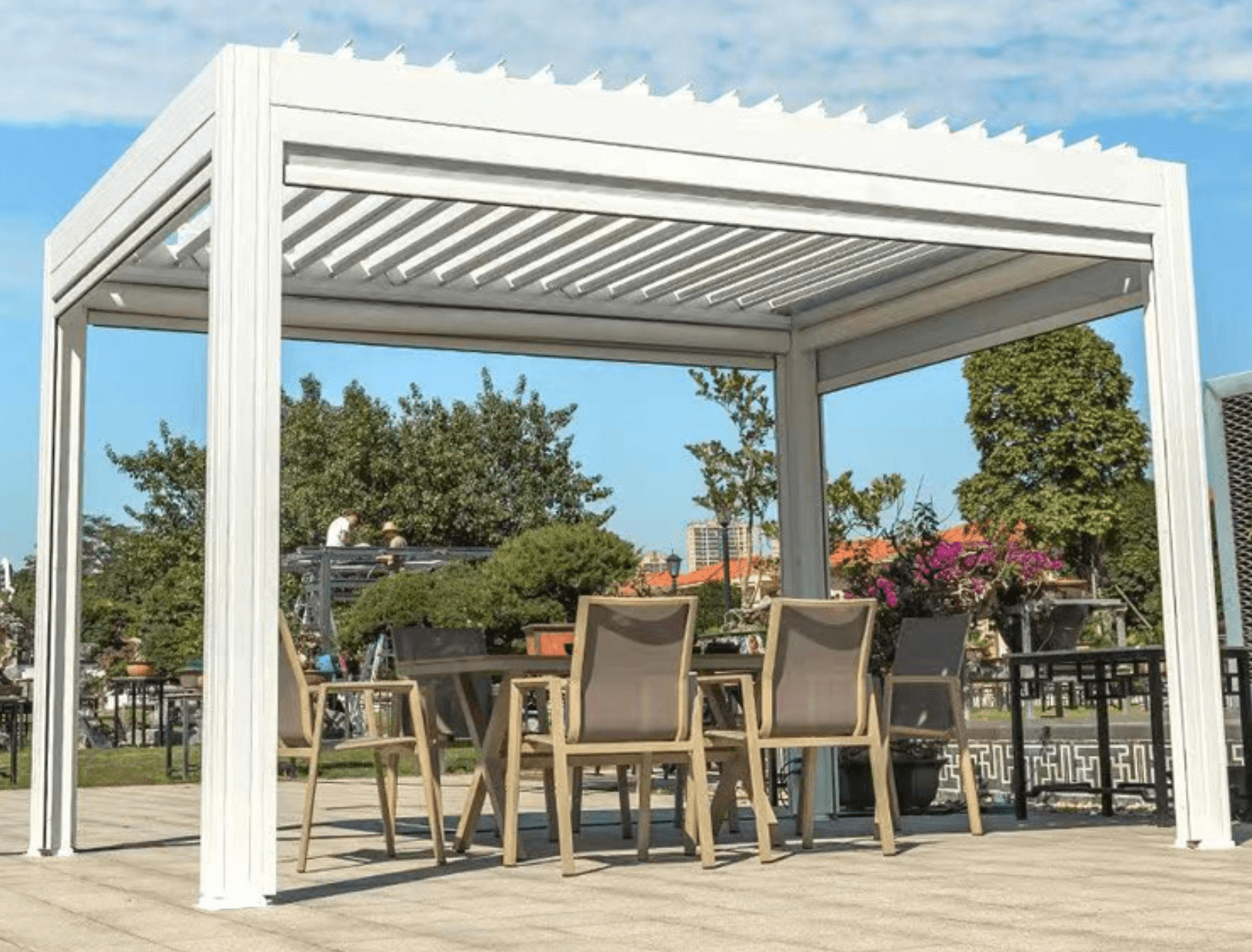 White freestanding pergola in an open commercial plaza setting