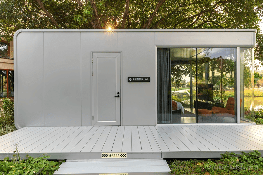 Modular home front entrance with entry door and wooden deck